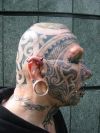 man with face tattoo